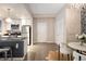 Modern kitchen featuring stainless steel appliances, hardwood floors, and a view of dining area at 1975 N Grant St # 617, Denver, CO 80203