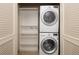 Convenient laundry closet with stacked washer/dryer and built-in shelving for storage at 1975 N Grant St # 617, Denver, CO 80203