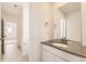 Bright bathroom with white vanity, gray countertop and tile flooring, plus large mirror at 2184 S Gold Bug Ct, Aurora, CO 80018