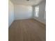 Bright, modern bedroom with wood-look flooring and two large windows at 2184 S Gold Bug Ct, Aurora, CO 80018