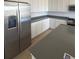 Modern kitchen with white cabinets, stainless steel appliances, and a gray countertop at 2184 S Gold Bug Ct, Aurora, CO 80018