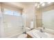 Well-lit bathroom featuring a shower/tub, toilet, sink, and a window offering natural light at 5405 Military Trl, Parker, CO 80134