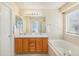 This is a bathroom with double sinks, a large mirror, and a separate soaking tub at 5405 Military Trl, Parker, CO 80134