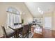 Bright dining room features hardwood floors, large windows, and modern chandelier at 5405 Military Trl, Parker, CO 80134