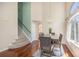 Elegant dining room with hardwood floors, a modern table, and a staircase view at 5405 Military Trl, Parker, CO 80134