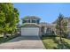 Charming two-story home with a well-manicured lawn, mature trees, and a two-car garage at 5405 Military Trl, Parker, CO 80134