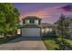 Charming two-story home with a well-manicured lawn, mature trees, and a two-car garage at 5405 Military Trl, Parker, CO 80134