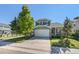 Charming two-story home with a well-manicured lawn, mature trees, and a two-car garage at 5405 Military Trl, Parker, CO 80134
