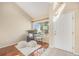 Bright foyer with hardwood floors, neutral walls, a reading chair and a large window at 5405 Military Trl, Parker, CO 80134