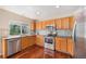 Well-lit kitchen with stainless steel appliances and wood cabinets at 5405 Military Trl, Parker, CO 80134