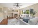 Inviting living room with a cozy fireplace, hardwood floors, and large windows offering natural light at 5405 Military Trl, Parker, CO 80134