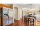 Open-concept living space with hardwood floors and stainless refrigerator at 5405 Military Trl, Parker, CO 80134