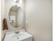 Bright powder room features a vanity and decorative mirror at 5405 Military Trl, Parker, CO 80134