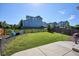 Spacious backyard with lush green grass, a concrete patio, and a charming fence providing privacy and tranquility at 1173 Basalt Ridge Loop, Castle Rock, CO 80108