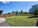 Large backyard featuring healthy lawn, wooden fence, and chairs at 1173 Basalt Ridge Loop, Castle Rock, CO 80108