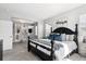 Primary bedroom featuring an ensuite bath, walk-in closet, and black four-poster bed at 1173 Basalt Ridge Loop, Castle Rock, CO 80108