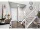 Inviting foyer with hardwood floors, staircase, decorative mirror, and stylish console table at 1173 Basalt Ridge Loop, Castle Rock, CO 80108