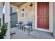 Inviting front porch featuring stone accents, seating, and a red entry door at 1173 Basalt Ridge Loop, Castle Rock, CO 80108
