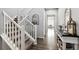 Welcoming hallway features hardwood floors, a staircase with white railings, and decorative accents at 1173 Basalt Ridge Loop, Castle Rock, CO 80108