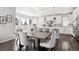 Elegant kitchen with white cabinets, a center island, and an adjacent dining area at 1173 Basalt Ridge Loop, Castle Rock, CO 80108
