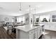 Open-concept kitchen with a large island, seating, and seamlessly connected living spaces at 1173 Basalt Ridge Loop, Castle Rock, CO 80108