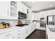 Modern kitchen featuring white cabinets, stainless steel appliances, and ample counter space at 1173 Basalt Ridge Loop, Castle Rock, CO 80108