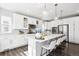 Stunning white kitchen with quartz countertops, stainless steel appliances, a large island, and stylish pendant lighting at 1173 Basalt Ridge Loop, Castle Rock, CO 80108
