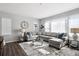 Spacious living room featuring an L-shaped gray sofa, decorative rug, and abundant natural light at 1173 Basalt Ridge Loop, Castle Rock, CO 80108