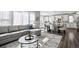 Bright, open-concept living area with a comfortable gray sectional sofa and modern decor at 1173 Basalt Ridge Loop, Castle Rock, CO 80108