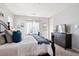 Comfortable main bedroom with a large bed, dark furniture, and windows with natural light at 1173 Basalt Ridge Loop, Castle Rock, CO 80108