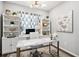 Bright home office with a marble-top desk, built-in shelving, and neutral decor at 1173 Basalt Ridge Loop, Castle Rock, CO 80108