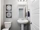 Well-appointed powder room featuring a pedestal sink, modern fixtures, and decorative wall art at 1173 Basalt Ridge Loop, Castle Rock, CO 80108