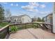 A wooden back deck with black metal railings overlooks the backyard and features potted ferns at 8114 Briar Ridge Dr, Castle Pines, CO 80108