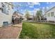 The backyard features a wooden deck, a large grassy area, and a partial fence, perfect for outdoor activities at 8114 Briar Ridge Dr, Castle Pines, CO 80108