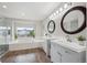 Bright bathroom with double vanities, soaking tub, and a separate glass shower at 8114 Briar Ridge Dr, Castle Pines, CO 80108