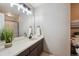 Bathroom features a vanity with dark wood cabinets, a large mirror and decorative light fixture above at 8114 Briar Ridge Dr, Castle Pines, CO 80108