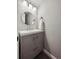 Stylish half bathroom with modern vanity, round mirror, and elegant fixtures at 8114 Briar Ridge Dr, Castle Pines, CO 80108
