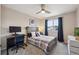 Cozy bedroom with ceiling fan, large window, and modern decor at 8114 Briar Ridge Dr, Castle Pines, CO 80108