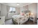 Comfortable bedroom with a floral patterned bedspread and two side tables at 8114 Briar Ridge Dr, Castle Pines, CO 80108
