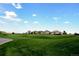 A beautiful community with well-manicured green spaces, picturesque homes, and scenic views under a bright sky at 8114 Briar Ridge Dr, Castle Pines, CO 80108