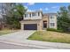 Charming two-story home with brick accents, a well-manicured lawn, and a two-car garage at 8114 Briar Ridge Dr, Castle Pines, CO 80108