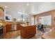 Spacious kitchen with stainless steel appliances, granite countertops, and a brick accent wall at 8114 Briar Ridge Dr, Castle Pines, CO 80108