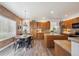 Eat-in kitchen includes wood cabinets, stainless steel appliances, granite countertops, and a breakfast nook at 8114 Briar Ridge Dr, Castle Pines, CO 80108