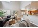 Open-concept living room seamlessly connects to kitchen with bar seating at 8114 Briar Ridge Dr, Castle Pines, CO 80108