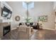 Bright living room with a fireplace, comfortable seating, and large windows for natural light at 8114 Briar Ridge Dr, Castle Pines, CO 80108