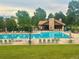 Community pool area with plenty of lounge chairs and trees at 8114 Briar Ridge Dr, Castle Pines, CO 80108