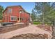 Expansive backyard featuring a stone patio, fountain, and manicured landscaping at 5784 W 81St Cir, Arvada, CO 80003