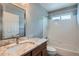 Bathroom featuring granite countertops, vanity, and a bathtub with a shower at 5784 W 81St Cir, Arvada, CO 80003