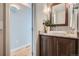 Stylish bathroom with a vessel sink, granite countertop, wood cabinetry, modern lighting and walk in shower at 5784 W 81St Cir, Arvada, CO 80003