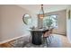 Elegant dining room featuring a table with seating for four, modern light fixture and a large window at 5784 W 81St Cir, Arvada, CO 80003